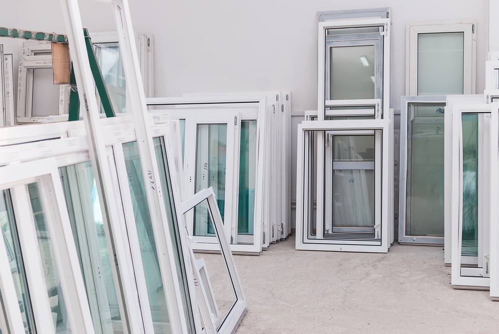 Many PVC windows stacked up against walls