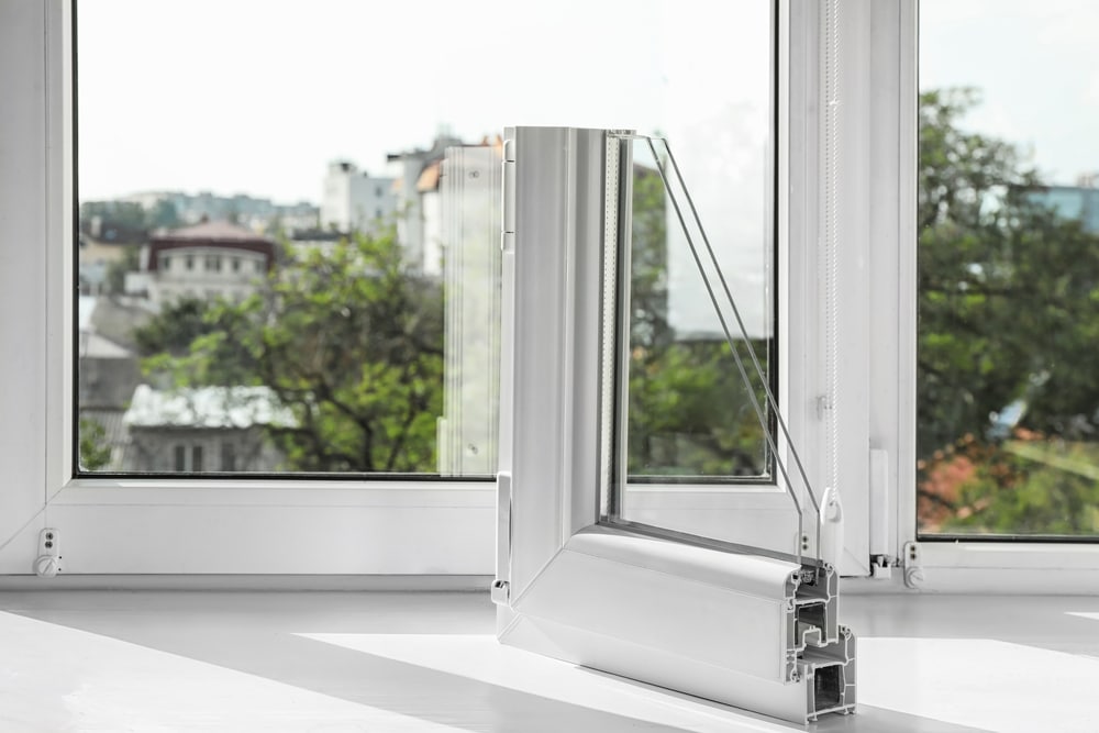 Sample of modern double-pane window profile in front of window