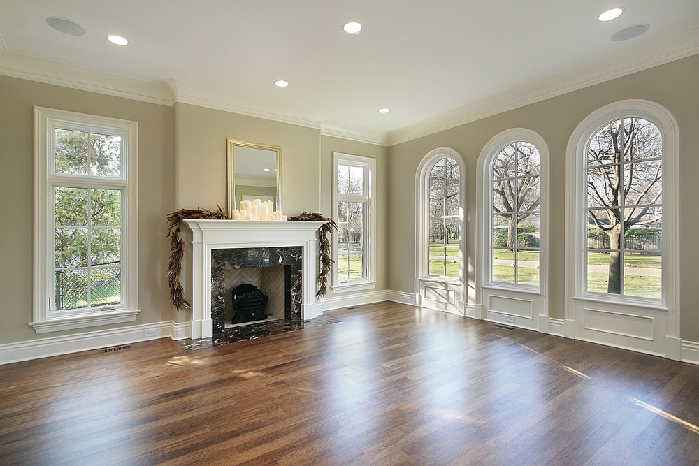 empty living room in new home with fireplace and big windows