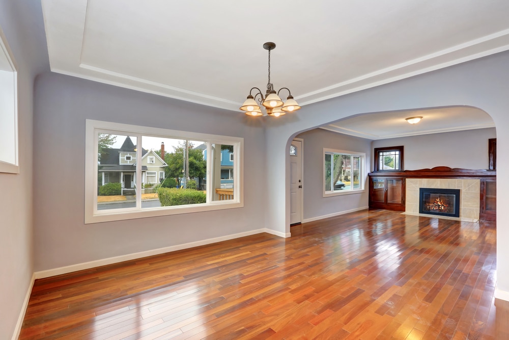 Empty living room with fireplace and windows